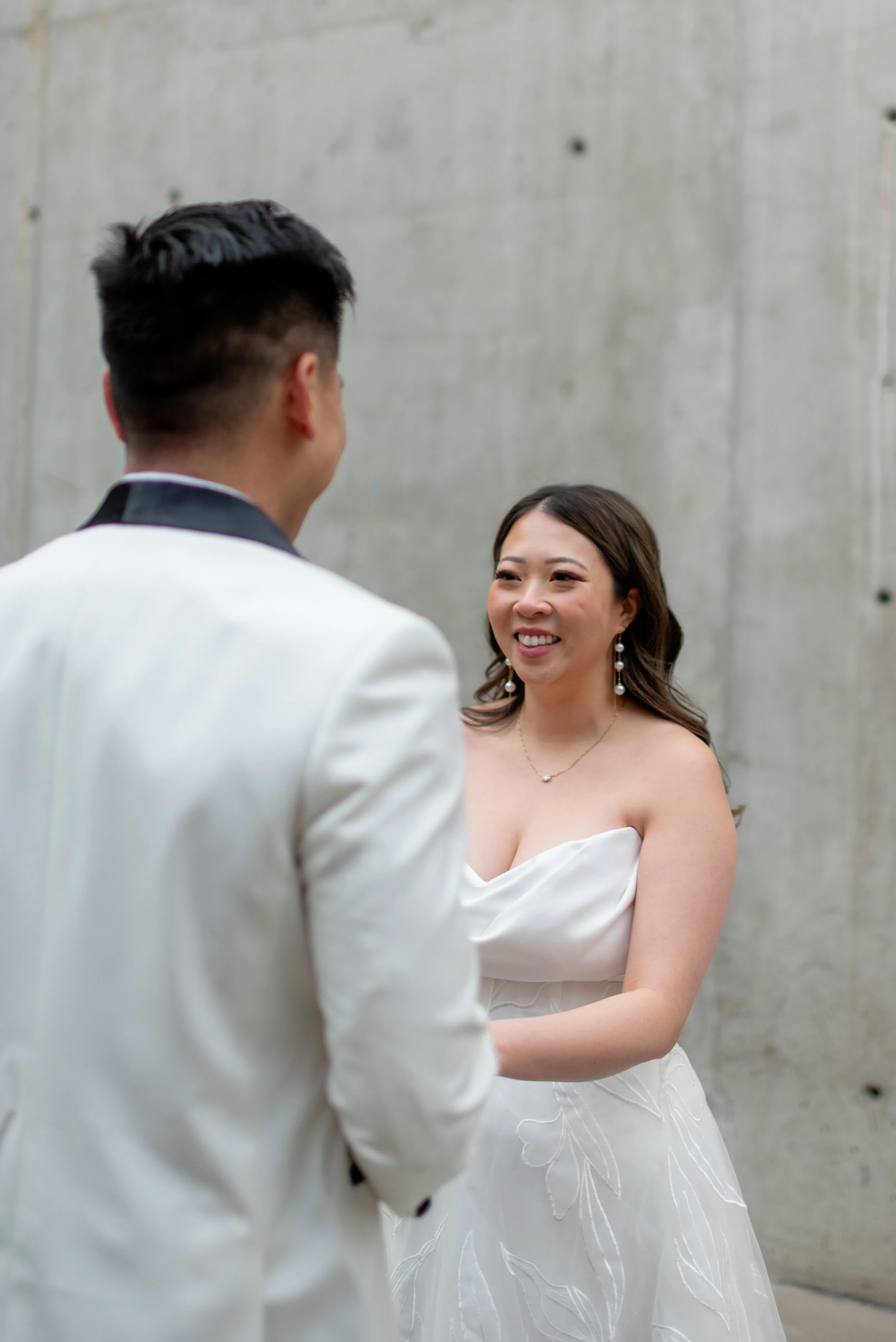Bride and groom holding hands with Calgary skyline visible