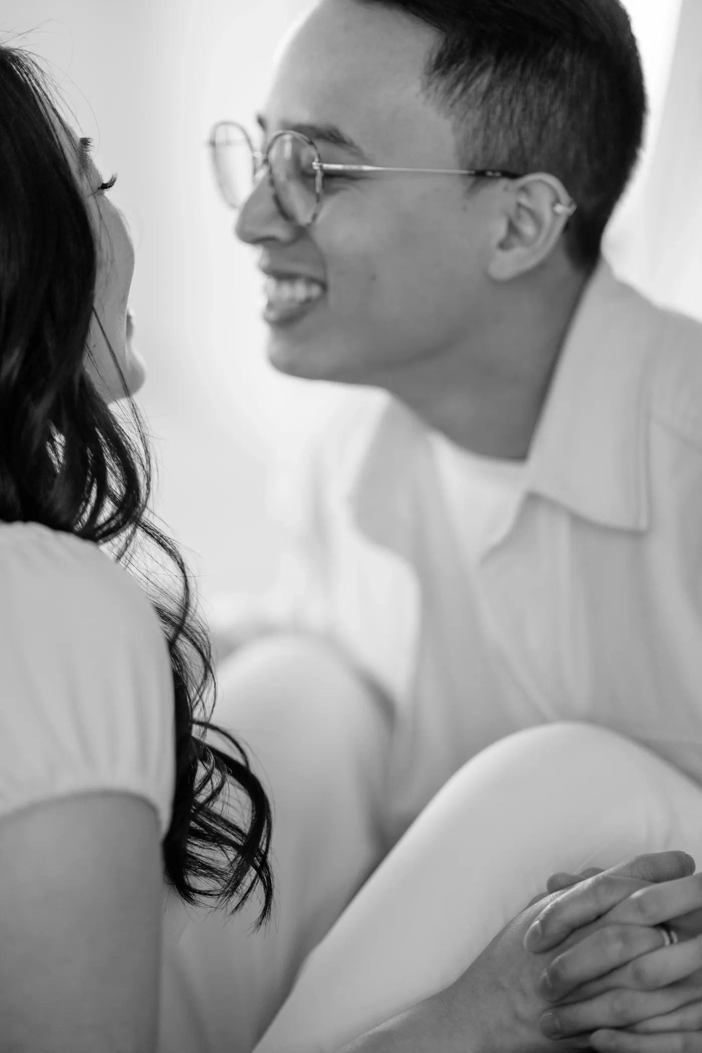 Artistic photo of engaged couple framed by The Covet Studio's iconic arched door, perfect for indoor engagement photography.