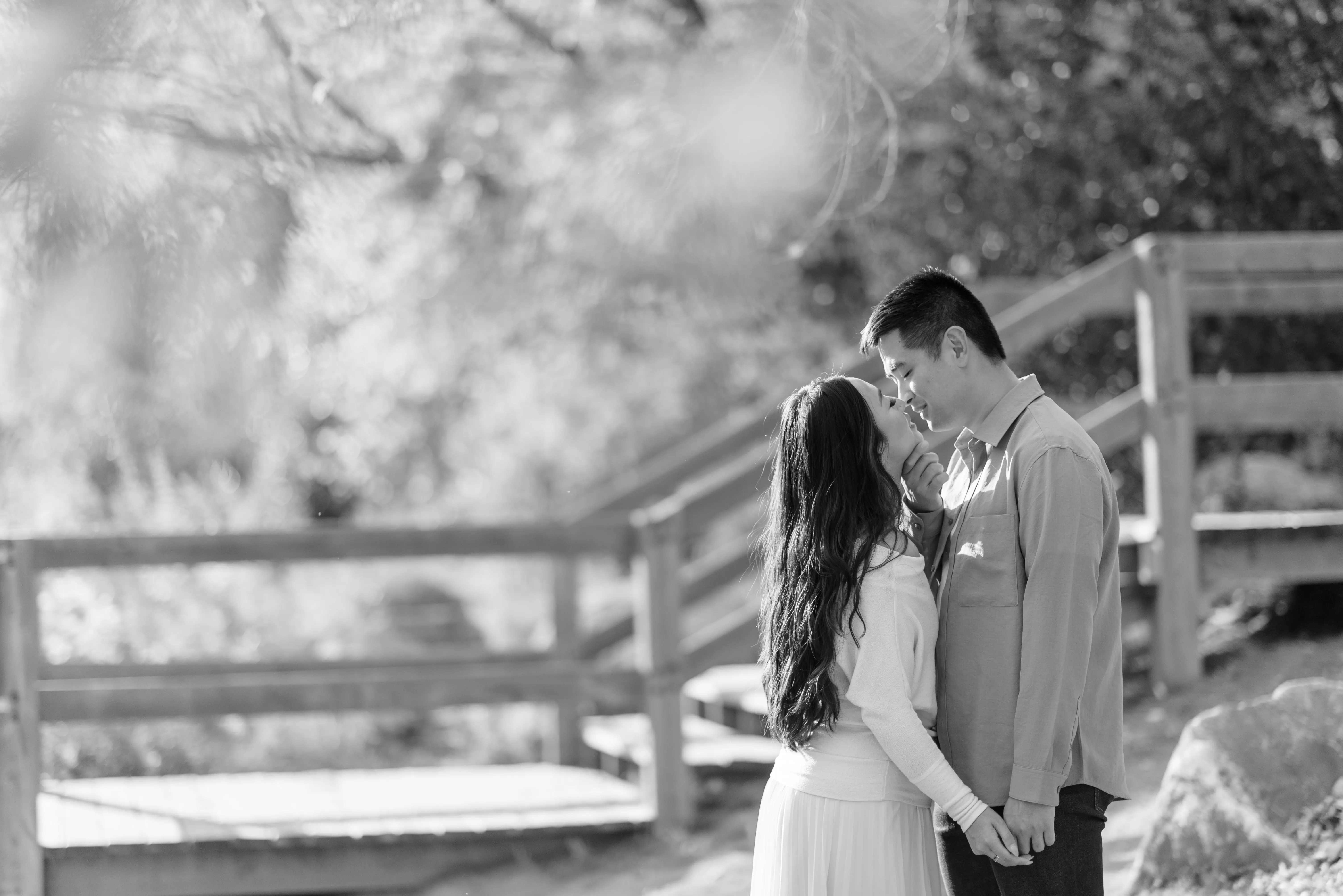 Couple embracing near Bow River at Prince’s Island Park Calgary