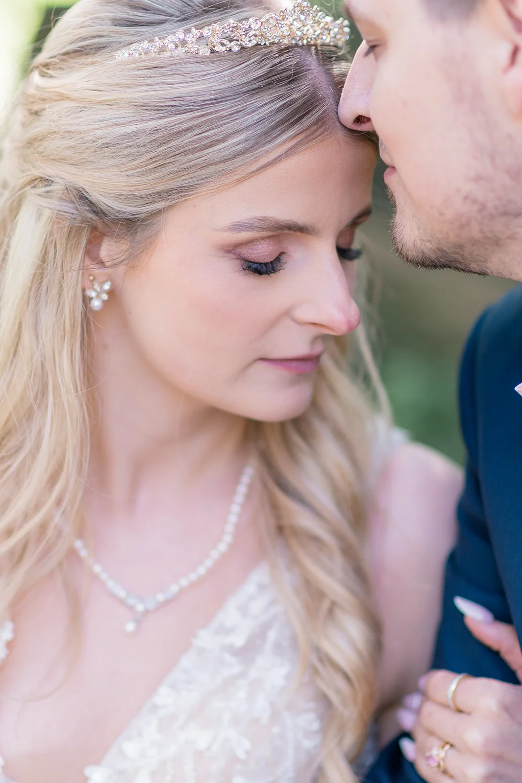 Bride and groom sharing a loving moment amidst the ethereal atmosphere of a forest, capturing the timelessness and wonder of their love story