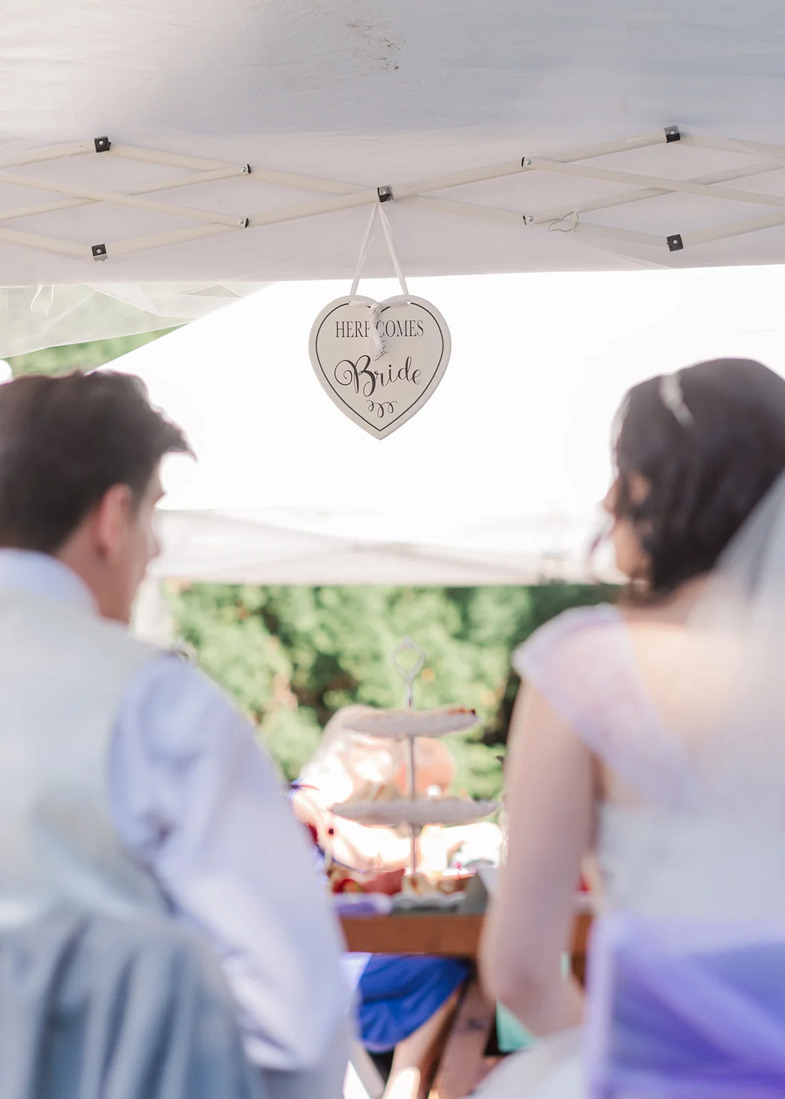 bride and groom sharing a drink at their reception in a summer backyard wedding in mission, british columbia