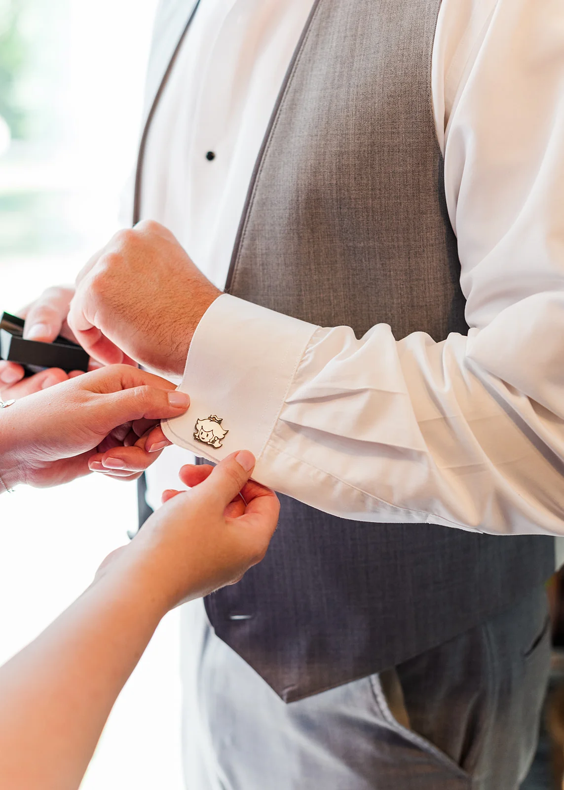 sister helping groom get ready on his wedding day in mission, british columbia