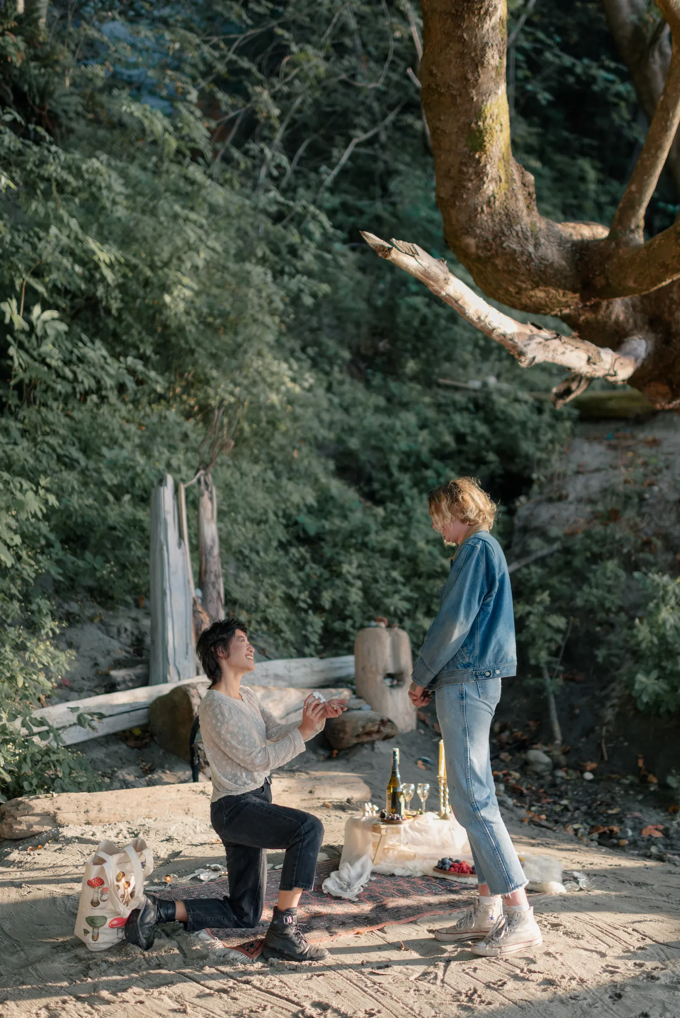 A heartfelt moment as one partner reads a handwritten love note during a surprise proposal in the Canadian outdoors. This intimate proposal was beautifully documented by a queer-friendly engagement photographer in Canada.