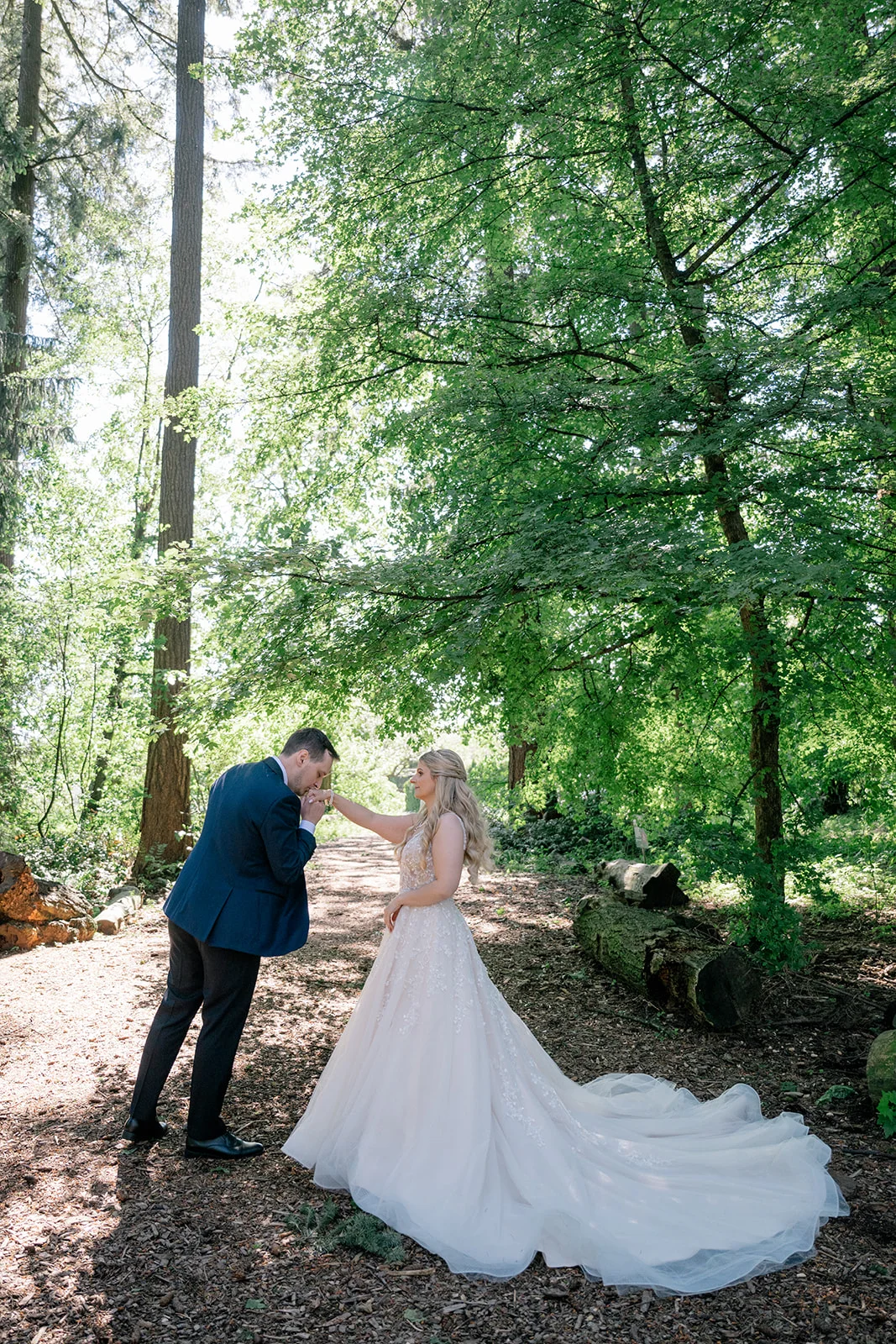 Bride and groom exuding fairy tale vibes in a lush forest, looking like they stepped straight out of a storybook