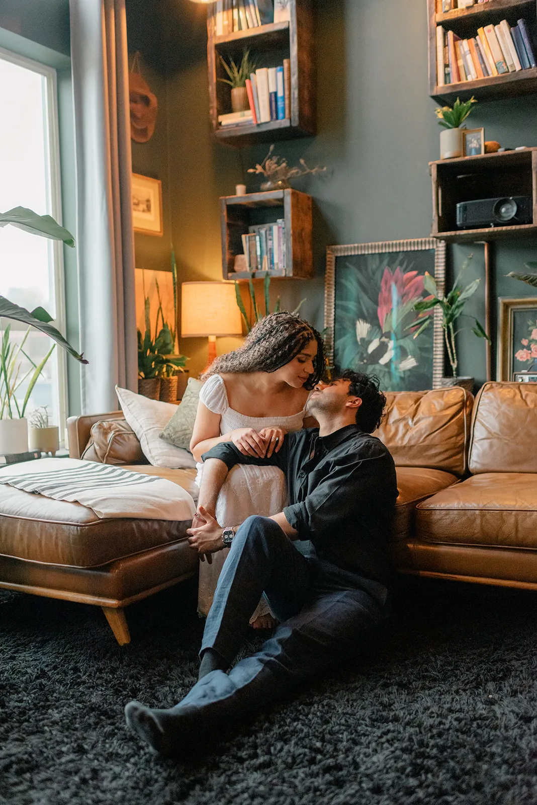 Couple lying together on a textured rug at Loft Garden Oasis, showcasing intimate moments and a cozy Vancouver photoshoot setting.