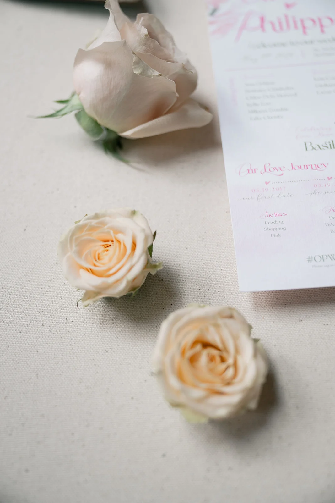 Beautiful wedding stationery featuring pink and white floral designs, including invitations, menus, and place cards.