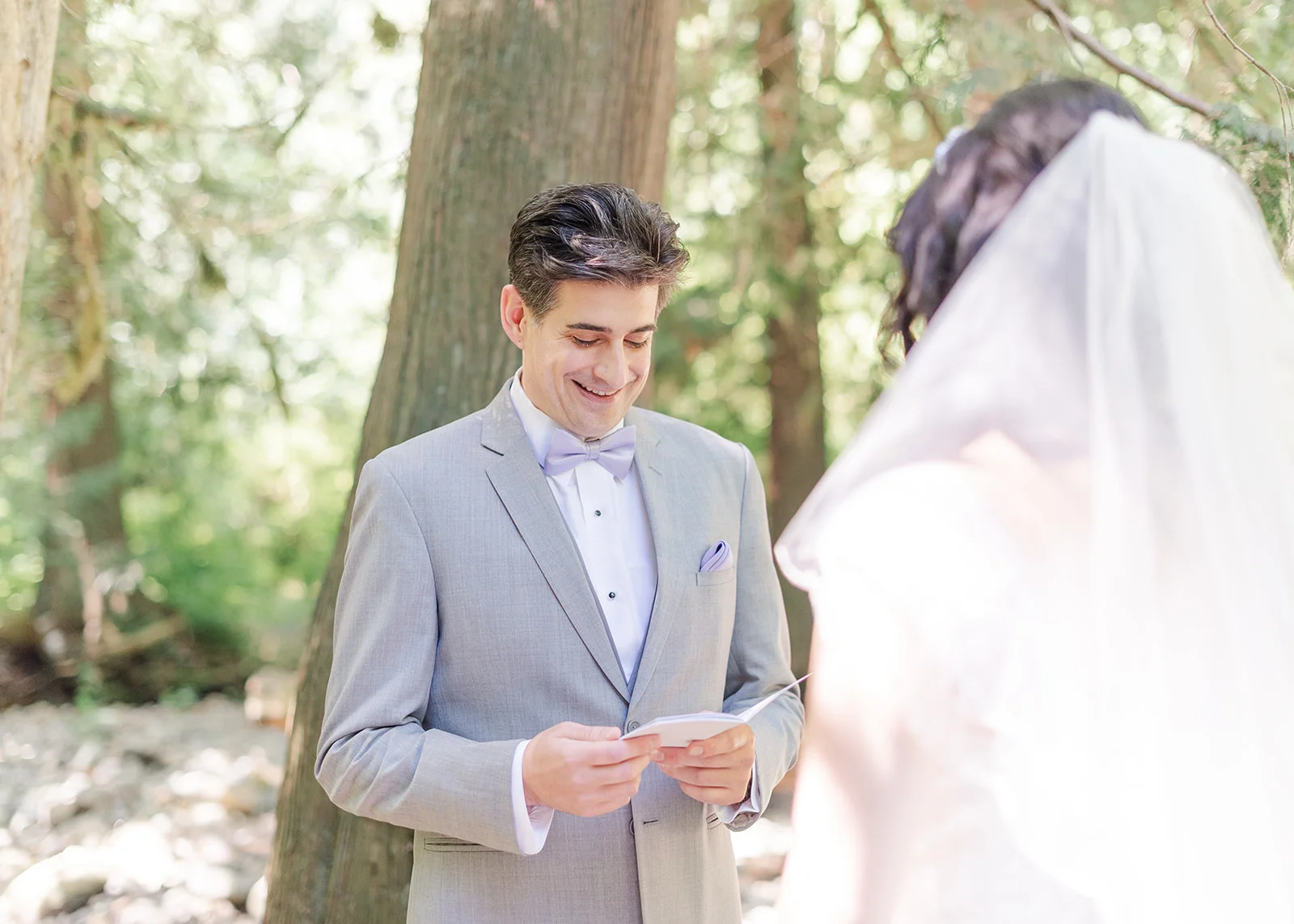 groom reading his vows to bride at a summer wedding in mission, british columbia