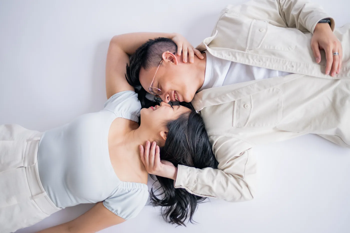 Playful moment captured between a couple leaning into each other, set in a beautiful indoor studio in Vancouver.