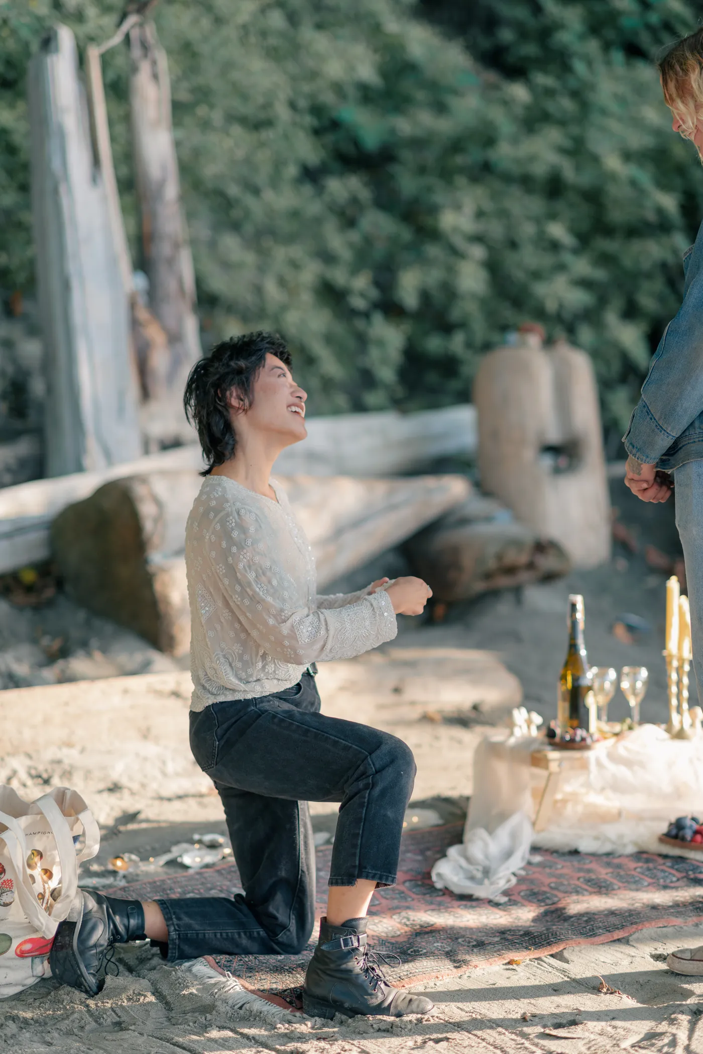 A heartfelt moment as one partner reads a handwritten love note during a surprise proposal in the Canadian outdoors. This intimate proposal was beautifully documented by a queer-friendly engagement photographer in Canada.
