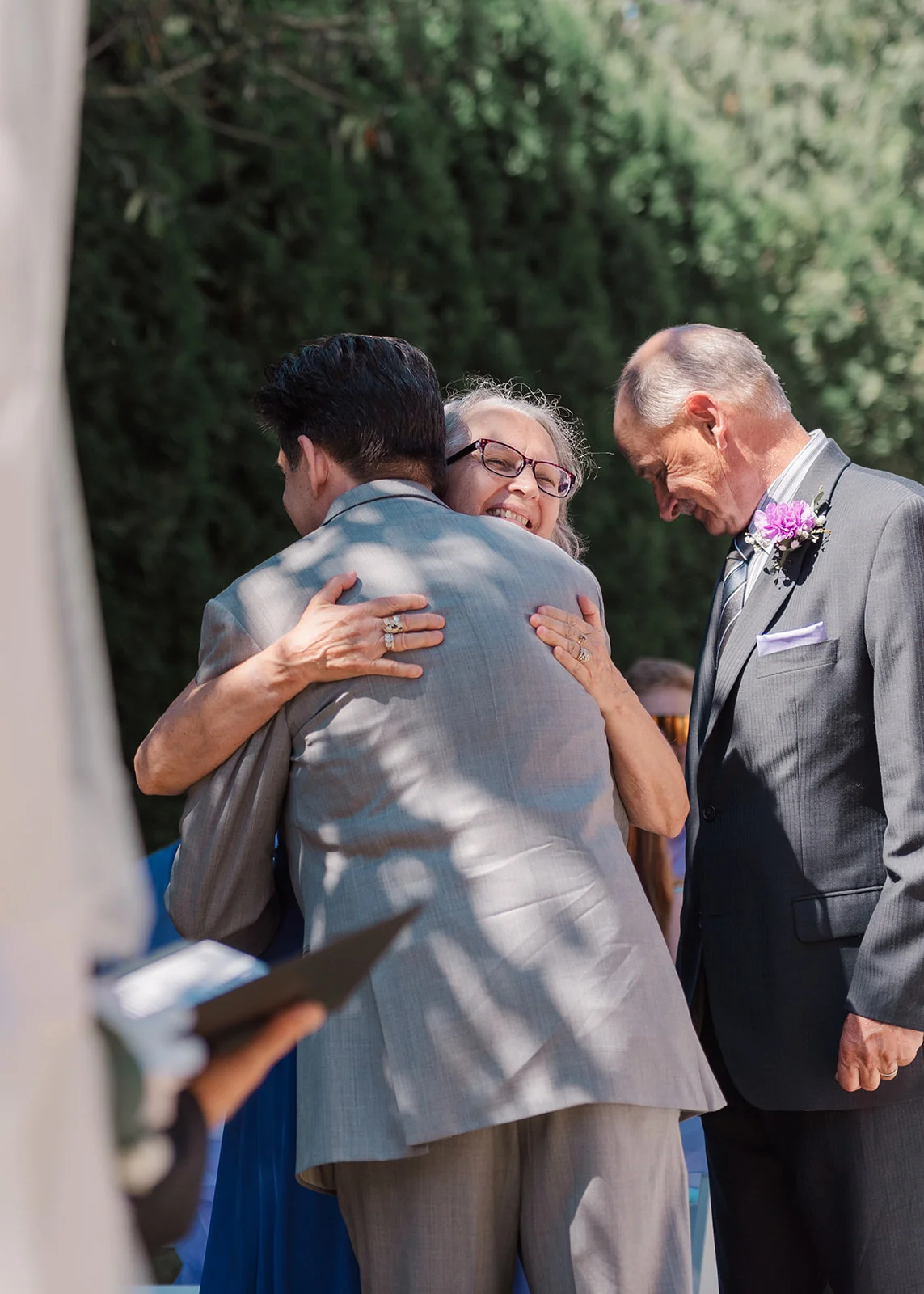 mom hugging groom at the aisle summer backyard wedding in mission, british columbia