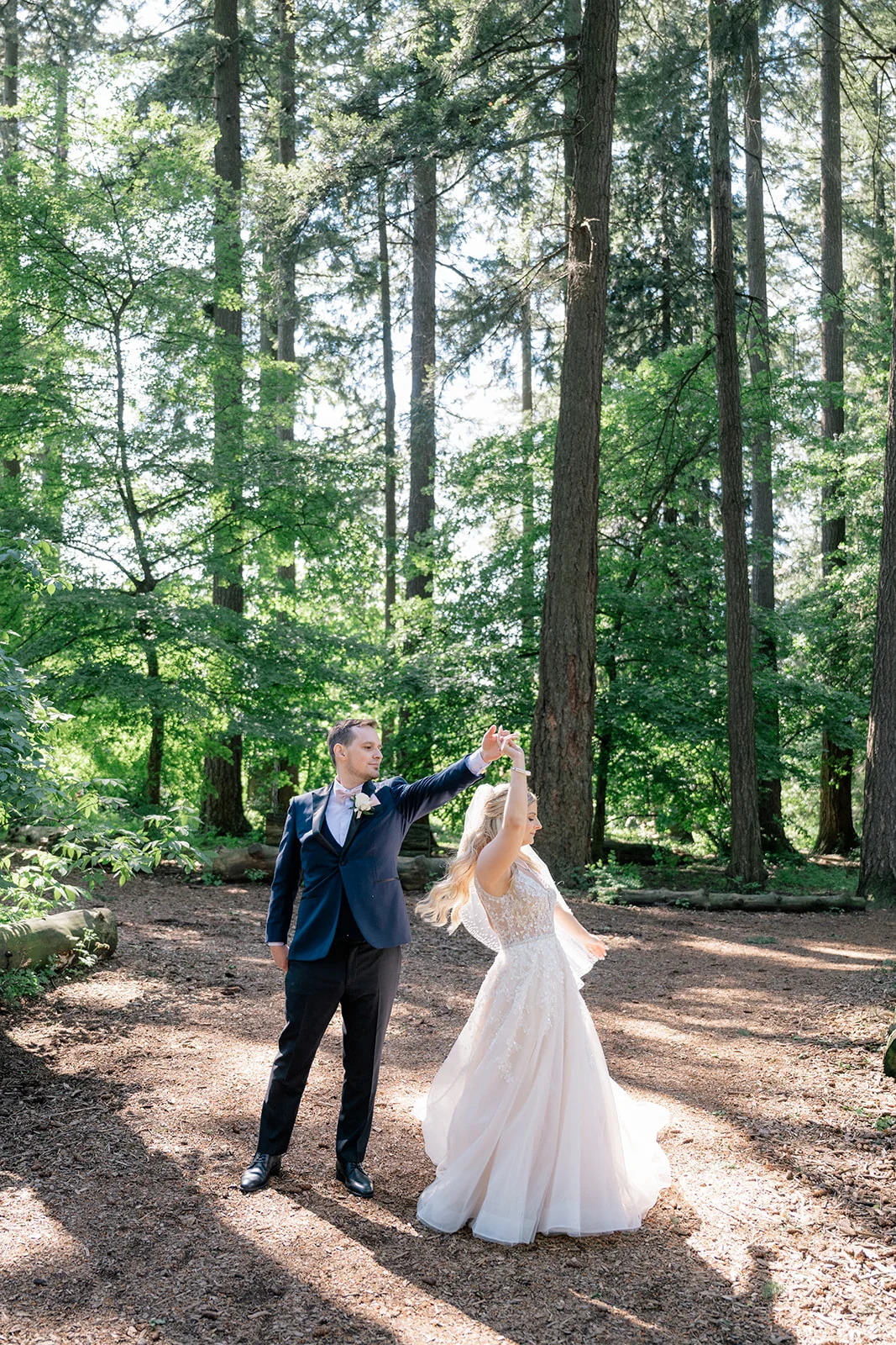 Bride and groom sharing a loving moment amidst the ethereal atmosphere of a forest, capturing the timelessness and wonder of their love story