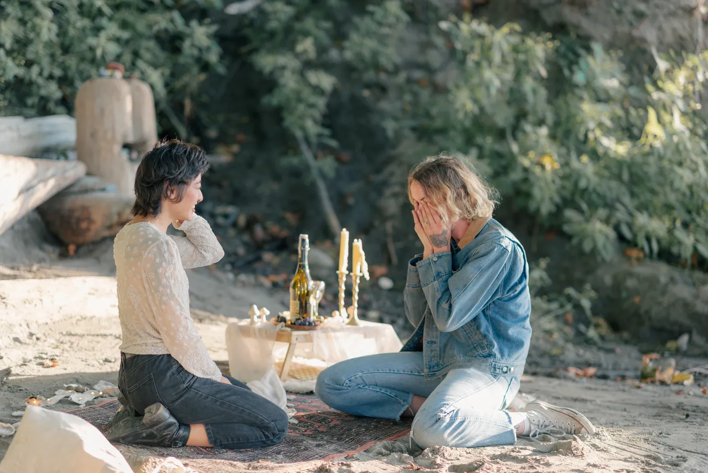 An emotional and romantic same-sex proposal in a forest setting, filled with love, joy, and celebration. A candid moment captured by a Canadian LGBTQ+ engagement photographer.