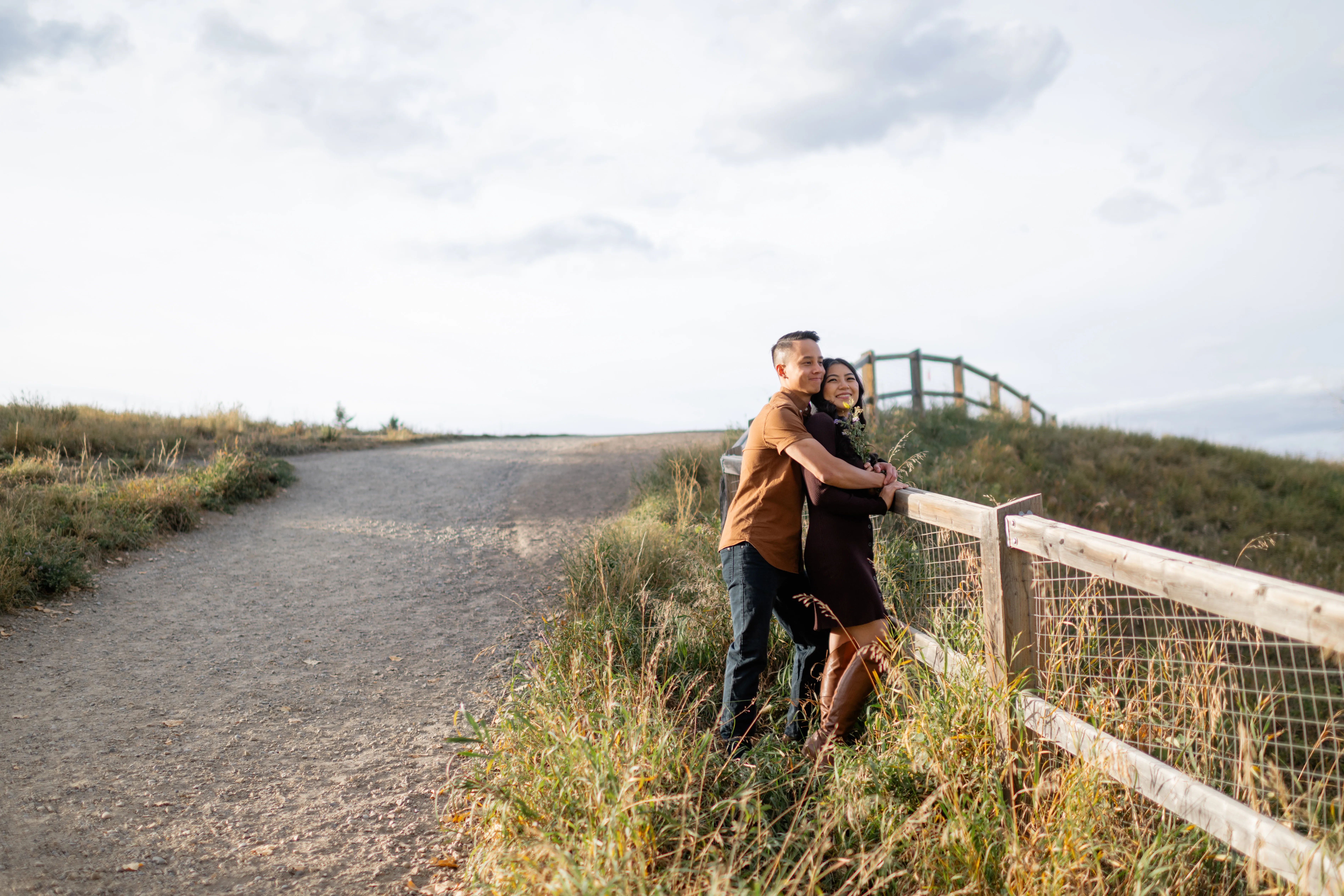 Wide shot of couple looking out towards Elbow River Calgary