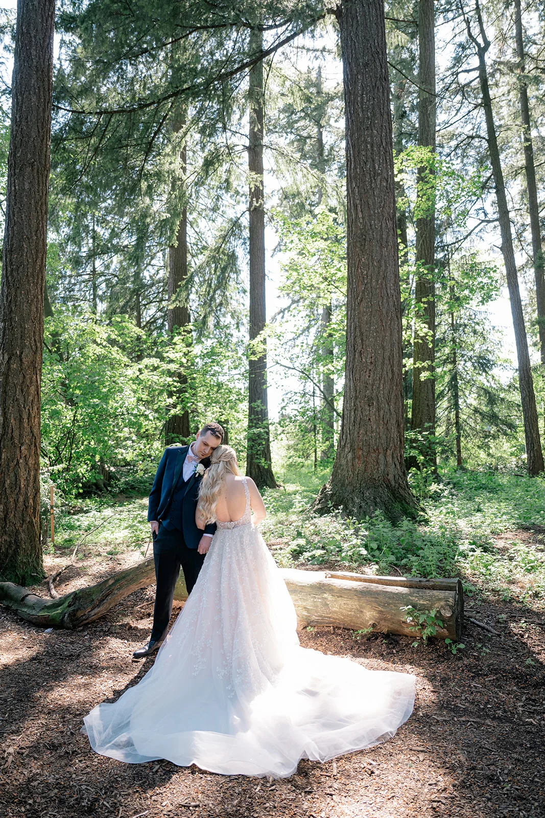 Bride and groom exuding fairy tale vibes in a lush forest, looking like they stepped straight out of a storybook