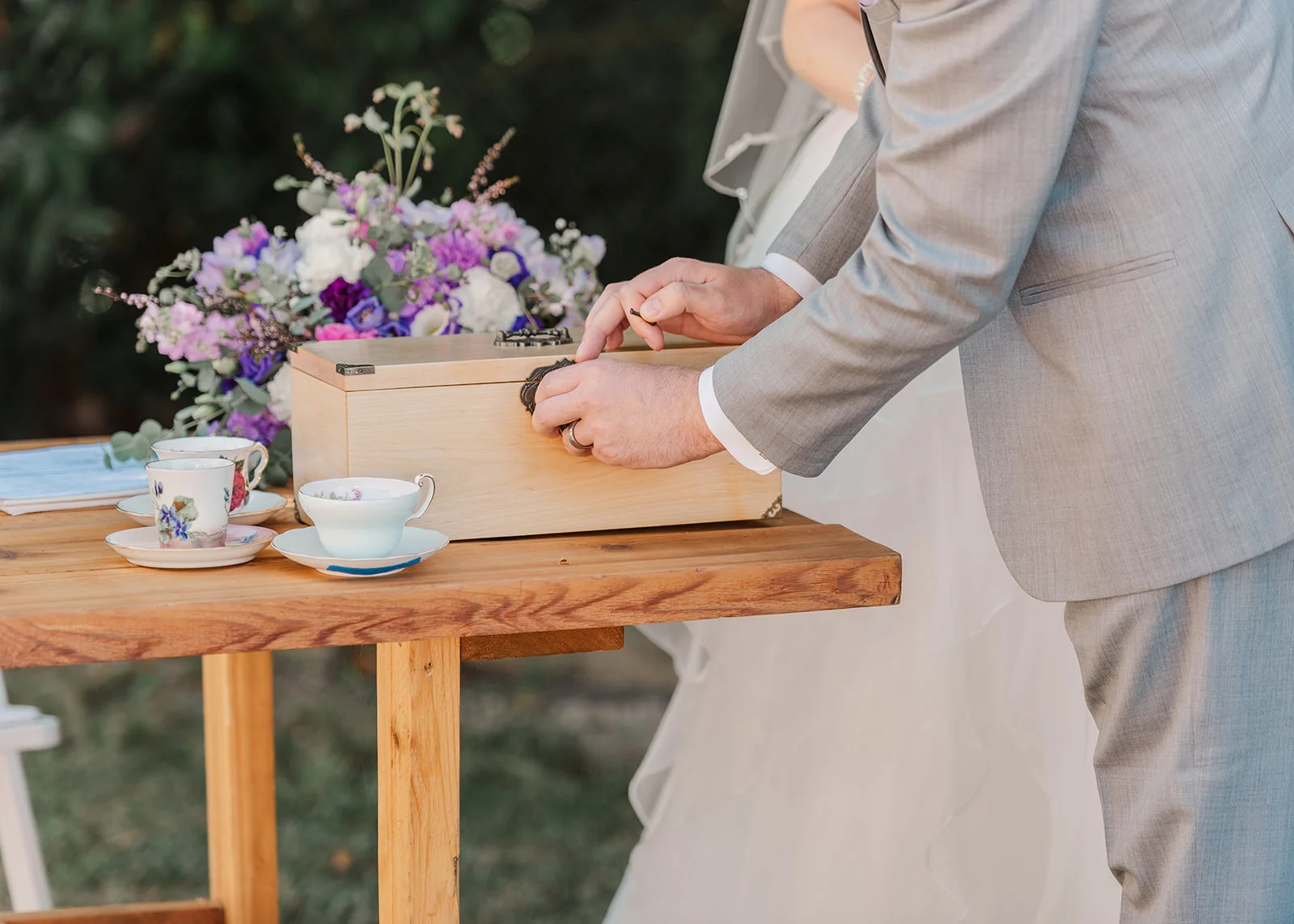 bride and groom sealing their vows in a box at their wedding certification at a summer backyard wedding in mission, british columbia