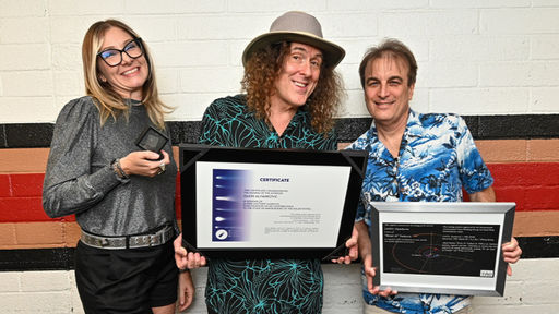 Dr. Allison McGraw, Weird "Al" Yankovic, and Dr. Steven Desch holding asteroid authentication certificate