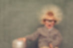 A boy with a shocked expression as he is using a static electric machine
