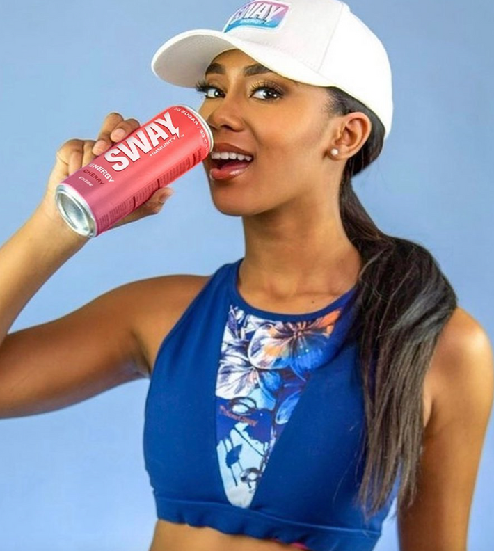 Fit woman drinking a sway energy drink 