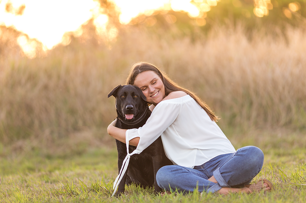 a girl hugging her black labrador during a Brisbane pet photography session