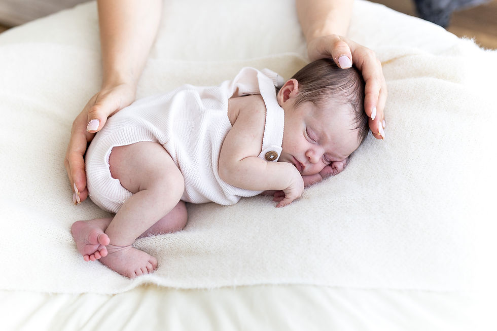 baby curled up asleep while mum holds her during a photography session in Brisbane