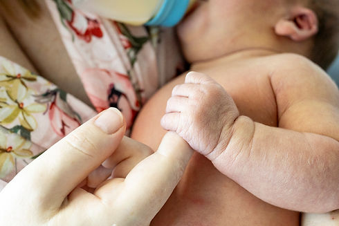 Fresh 48 newborn photography close up of mother holding baby’s hand in hospital