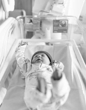Fresh 48 newborn photography of baby lying in hospital bassinet