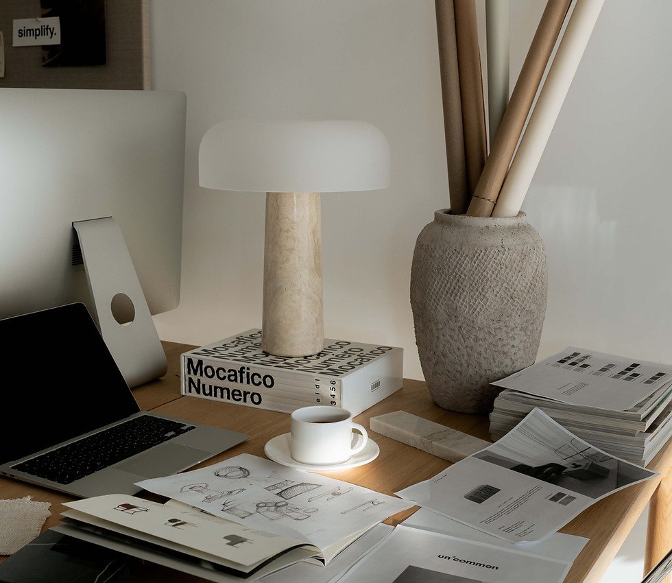 Workspace with a laptop, lamp, books, and coffee cup ABOUT rubysignorelli.com