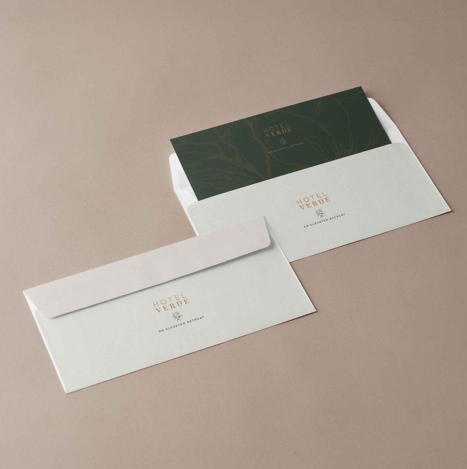 Envelope and note card with green and blush palette — minimal print collateral expressing botanical elegance.