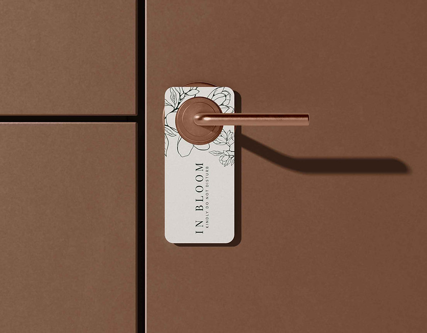Door hanger with floral illustration — refined guest-room collateral emphasizing brand serenity.