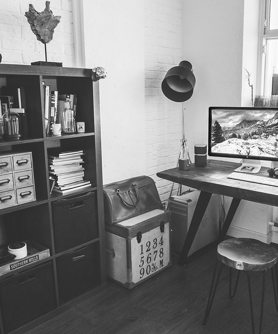 Monochrome home office with desk, computer, shelf, and chair. ABOUT Interior design. rubysignorelli.com