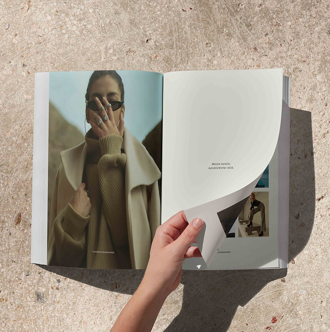 Flat-lay of multiple Maison Aurélia magazines — cohesive publication design and consistent visual identity.