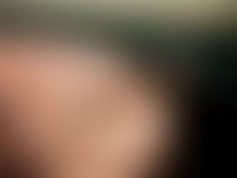 A lit joint in a pink ashtray.