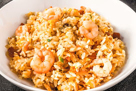 A plate of delicious fried rice with shrimp, egg, and vegetables. The rice is fluffy and the shrimp are plump and juicy.