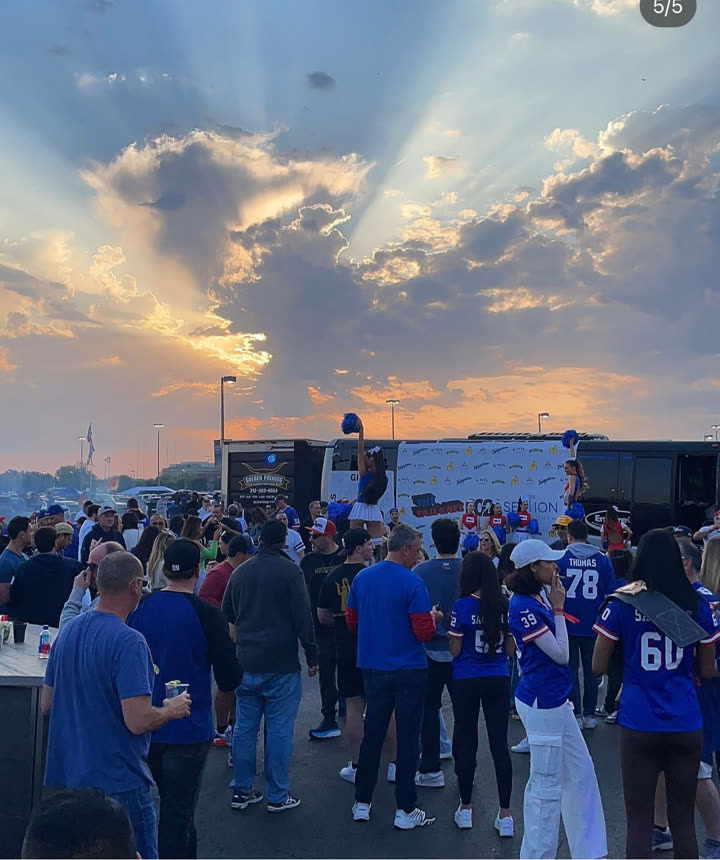 Guests arriving at a charity tailgate activation at dusk