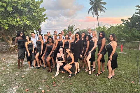 Event staff in matched black dress code on site at an outdoor evening event