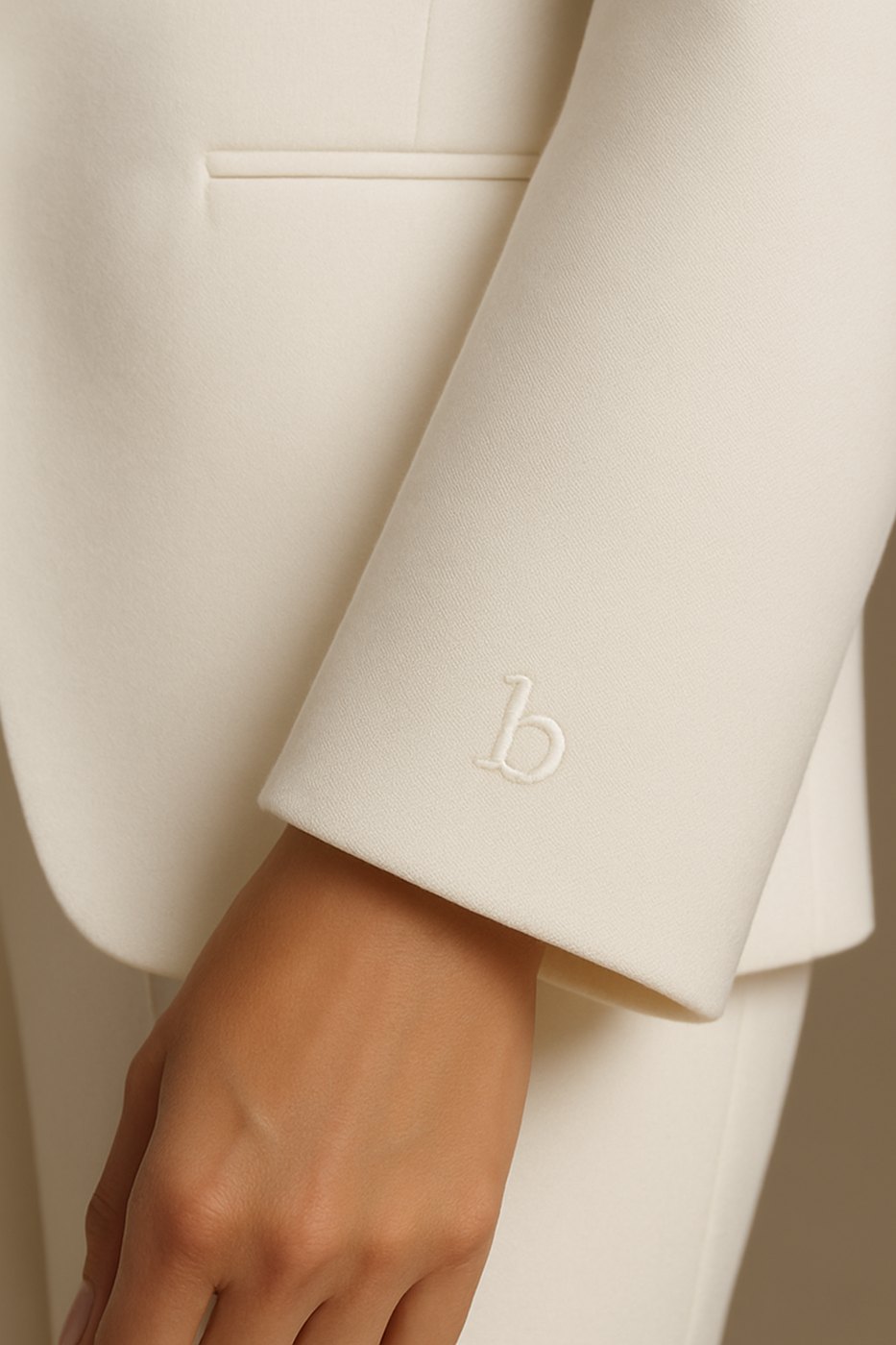The embroidered monogram detail on the wardrobe cuff