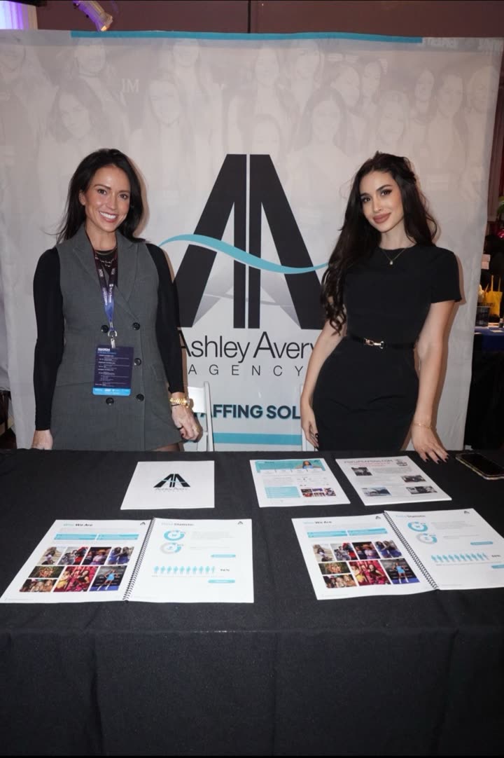 Agency staff briefing visitors at the Ashley Avery Agency expo booth