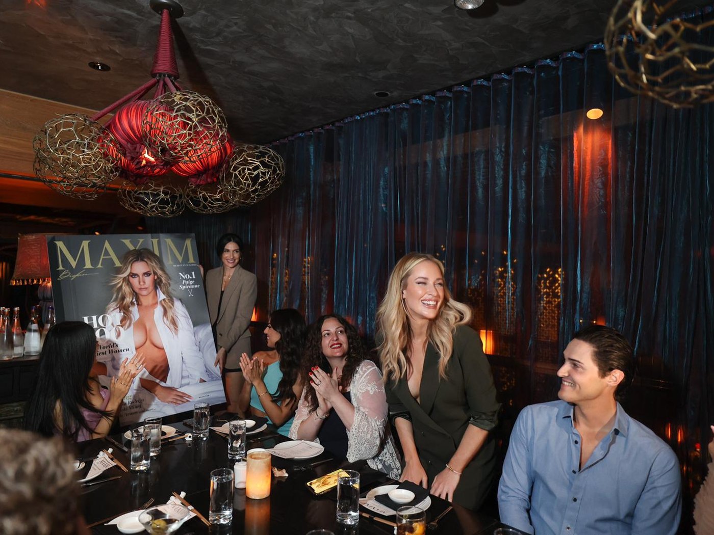 Guests at the Hot 100 cover dinner at Tao Downtown, applauding the cover unveiling