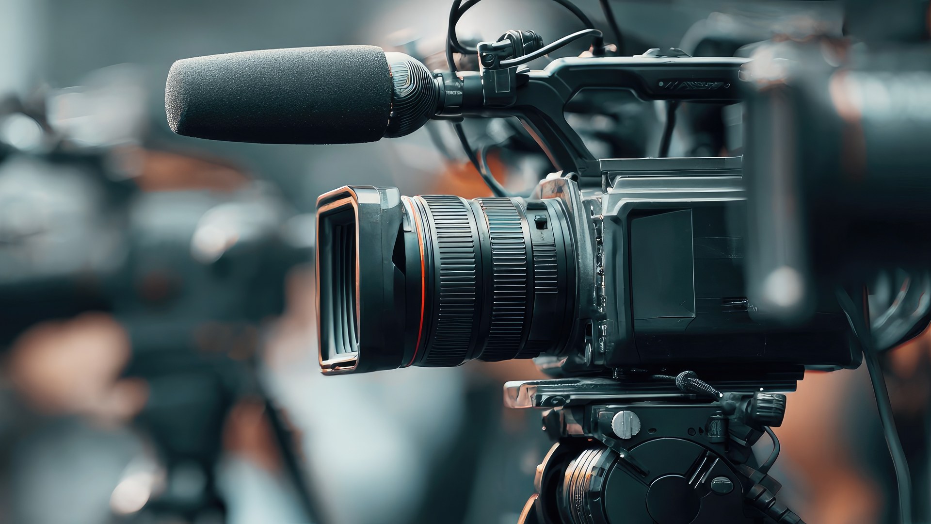 Broadcast camera and shotgun microphone covering a press event
