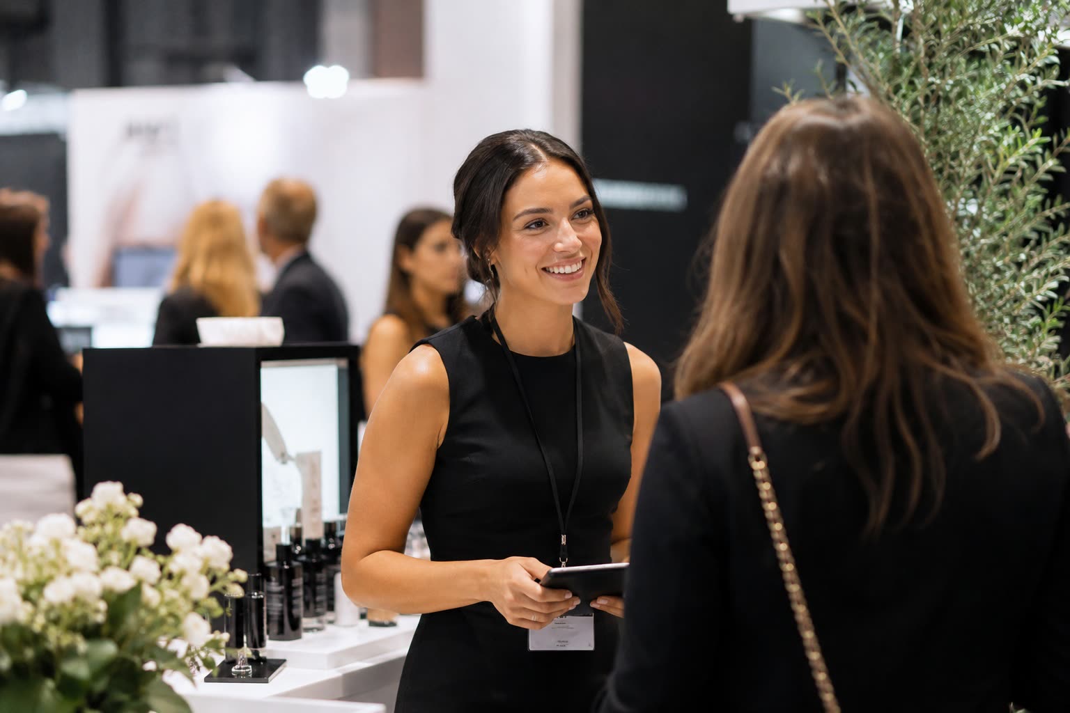 Ashley Avery Agency brand ambassador speaking with a guest at a trade-show activation
