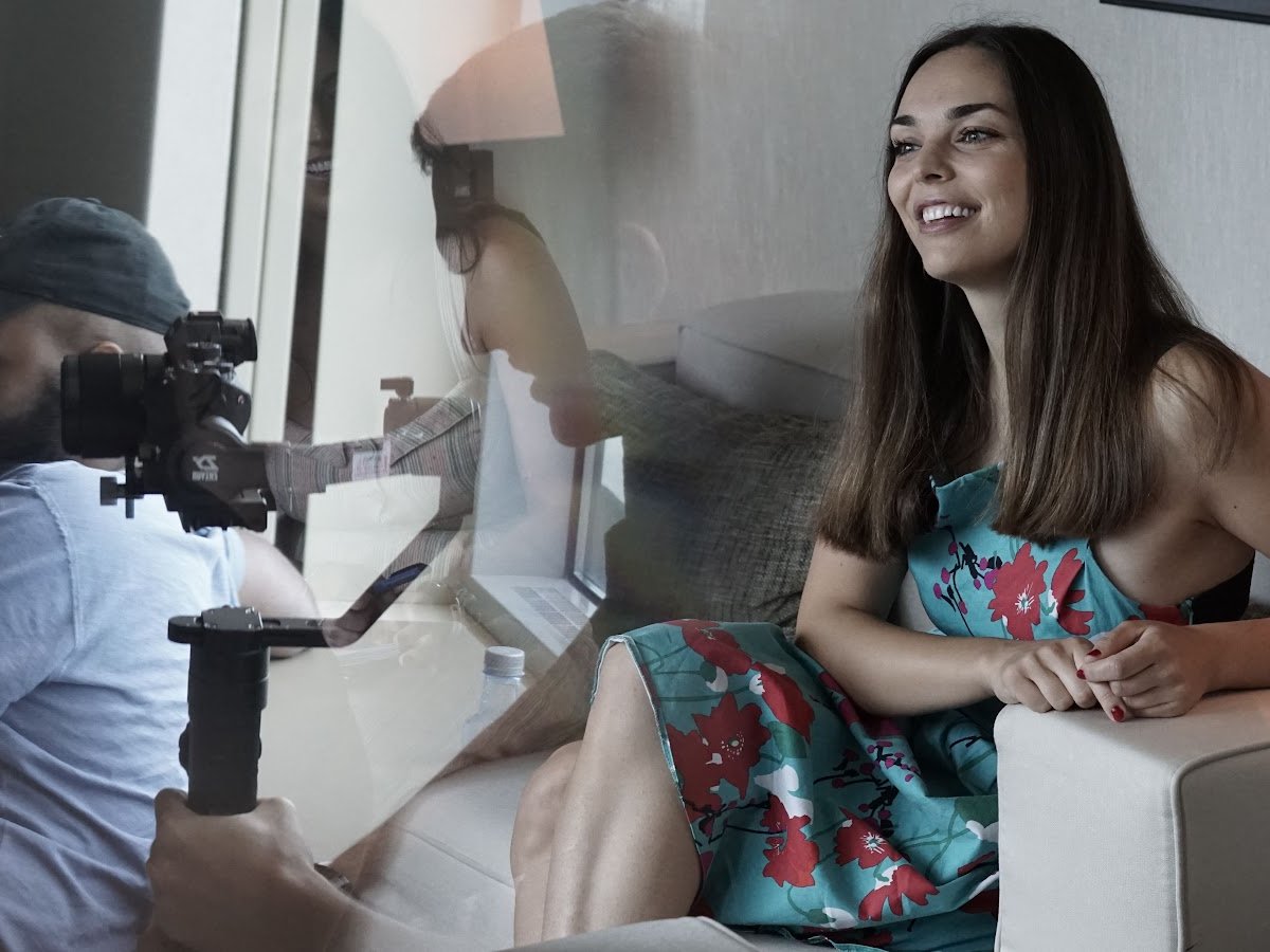 A camera operator filming a candidate interview in Barcelona