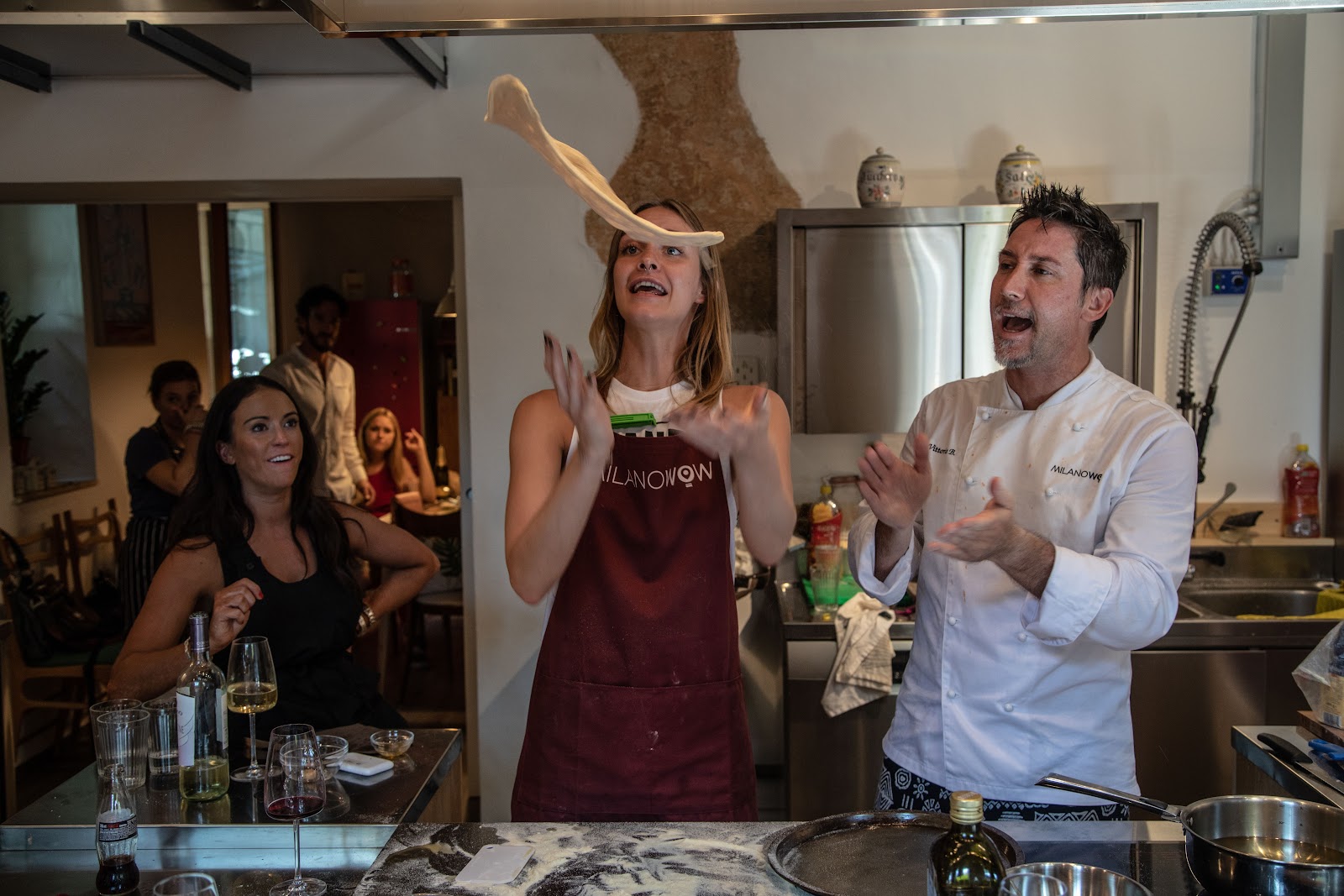 A private cooking class in Milan arranged for the program, a chef guiding participants