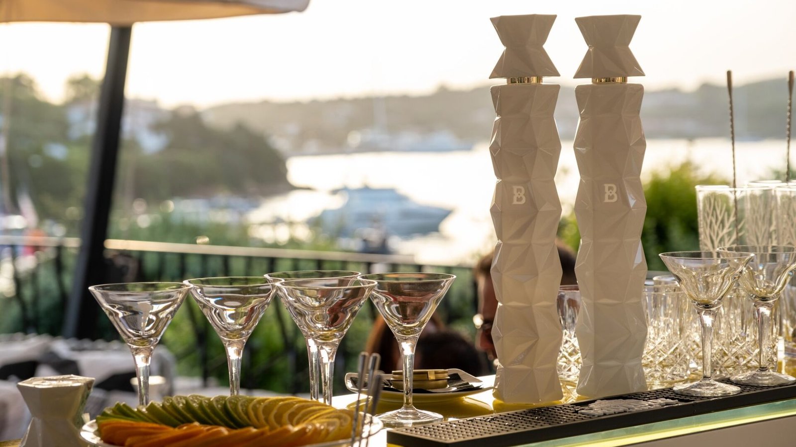 Belvedere 10 bottles and prepared glassware on the bar at a waterfront sampling activation at golden hour