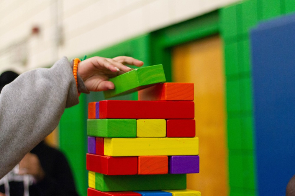 Hand stacking colored blocks