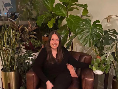 Plant parent of 50, Kirby Reber in front of some of her plant babies in her Old Town apartment. Photo courtesy of Kirby Reber.