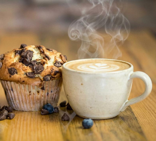 Two muffins and steaming coffee, perfect breakfast