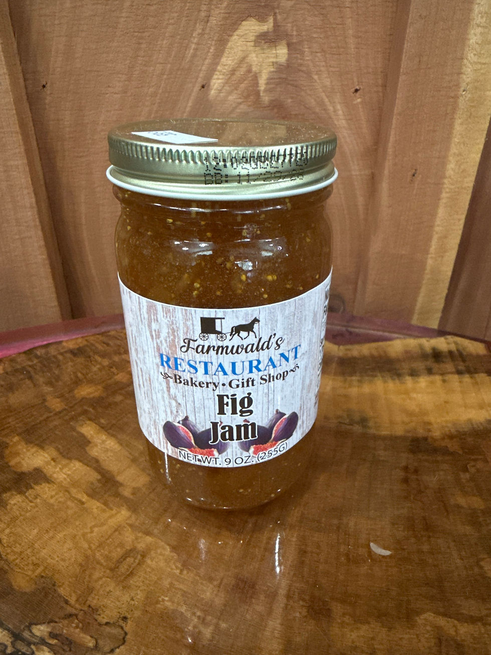 Farmwald's Fig Jam 9oz jar on a wooden surface