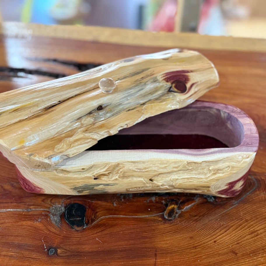 Cedar log jewelry box with hinged lid partially open