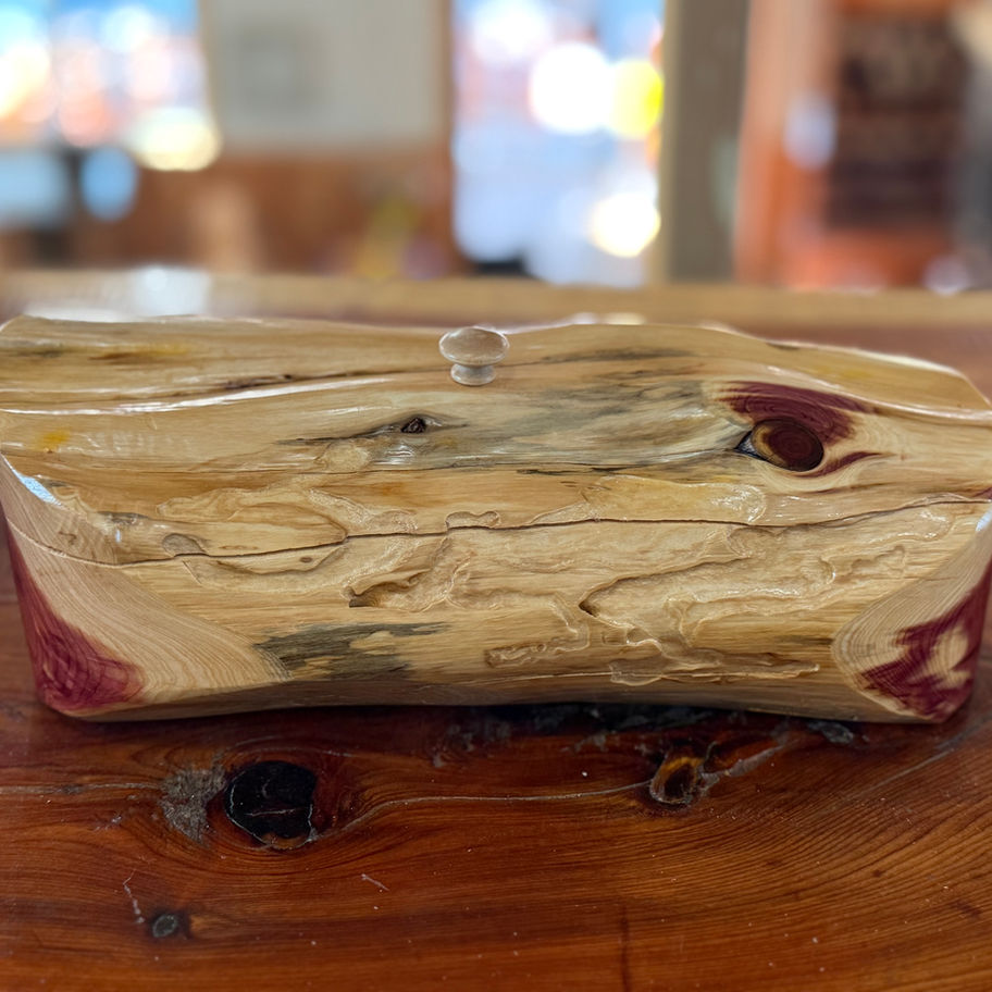 Cedar log jewelry box with hinged lid and natural finish.