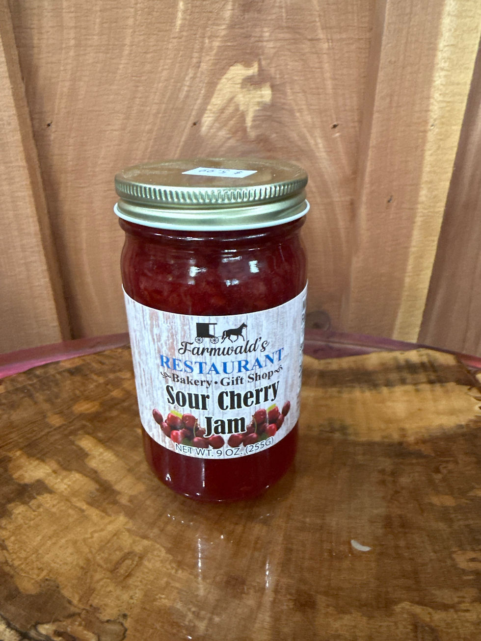 Farmwald's Sour Cherry Jam 9oz jar on a wooden surface